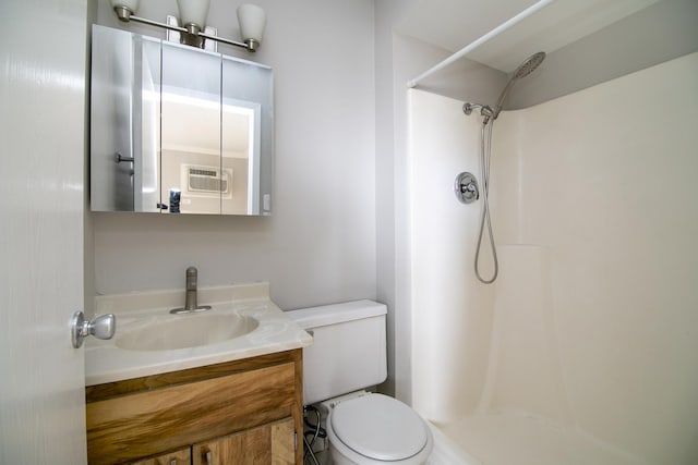 bathroom with a shower, vanity, toilet, and a wall mounted air conditioner