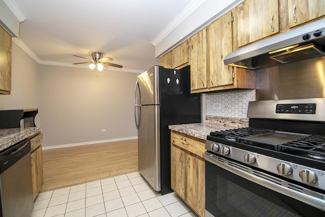 kitchen featuring appliances with stainless steel finishes, under cabinet range hood, ceiling fan, ornamental molding, and decorative backsplash