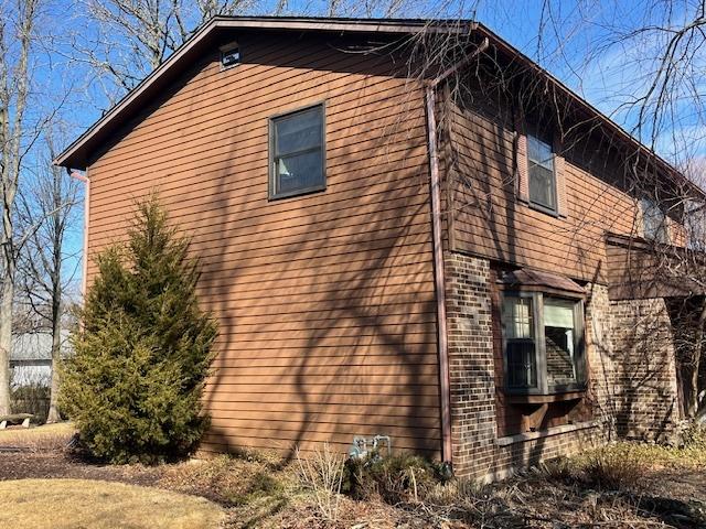 view of property exterior featuring brick siding