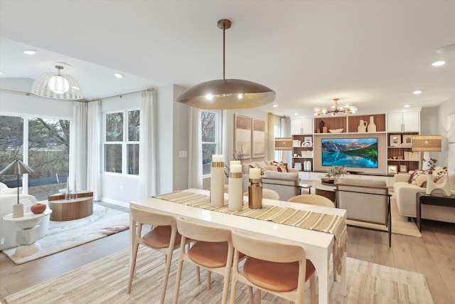 dining area featuring a chandelier, light wood finished floors, and recessed lighting