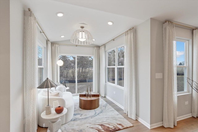 sitting room featuring lofted ceiling, baseboards, recessed lighting, and wood finished floors