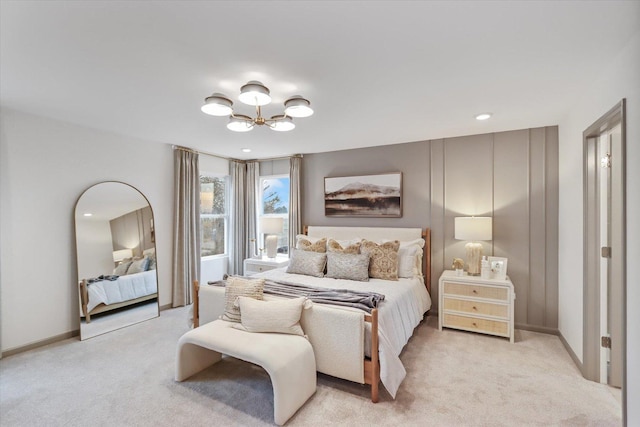 bedroom with baseboards, a notable chandelier, and light colored carpet