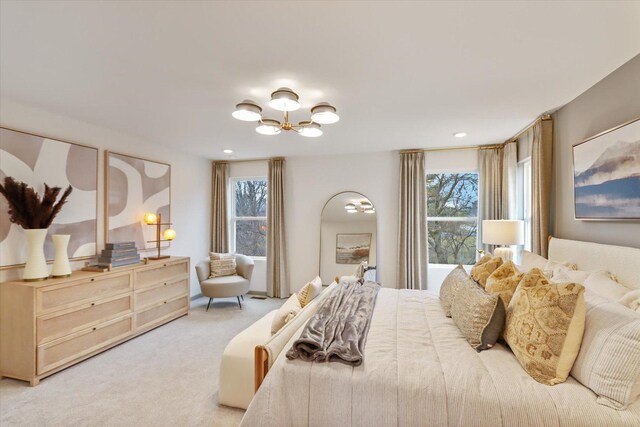 bedroom featuring a chandelier, carpet floors, and arched walkways