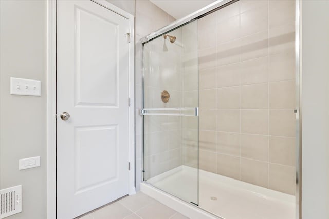 full bathroom featuring a stall shower, tile patterned flooring, and visible vents