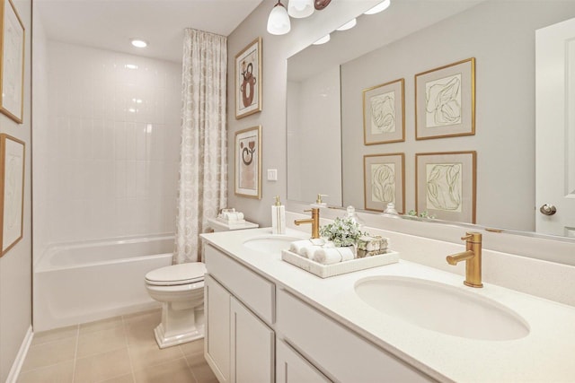 full bathroom featuring double vanity, tile patterned flooring, a sink, and toilet