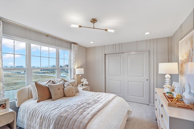 bedroom with a closet and light colored carpet