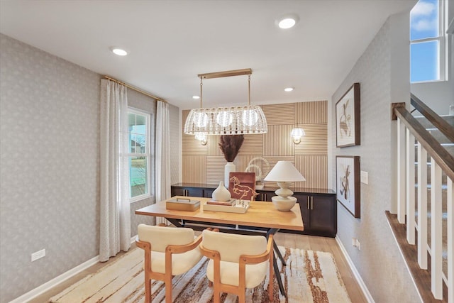 dining space featuring wallpapered walls, stairway, light wood finished floors, and recessed lighting