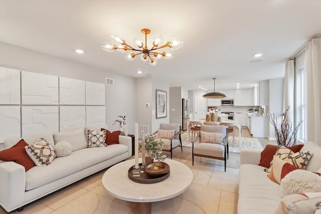 living room with an inviting chandelier, visible vents, and recessed lighting