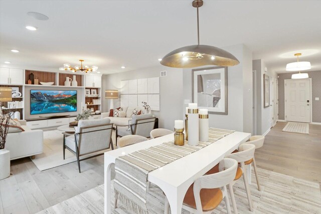 dining room featuring a notable chandelier, light wood finished floors, and recessed lighting