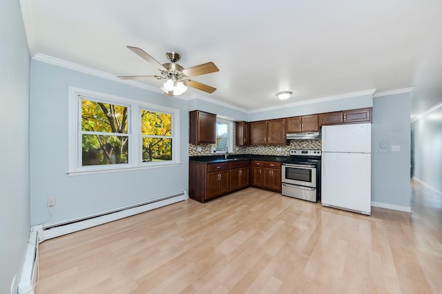 kitchen with a baseboard heating unit, backsplash, dark countertops, freestanding refrigerator, and stainless steel electric range