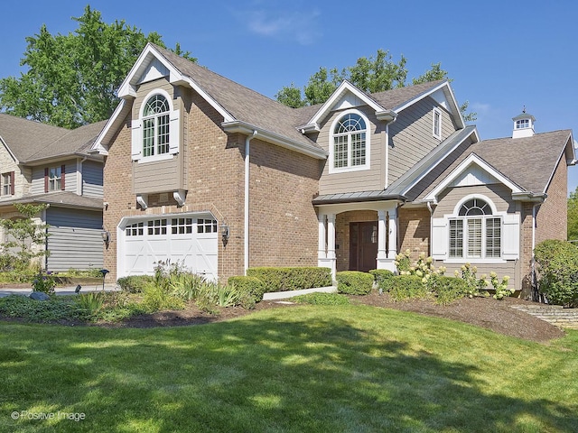 view of front of house featuring a front lawn, a garage, and brick siding