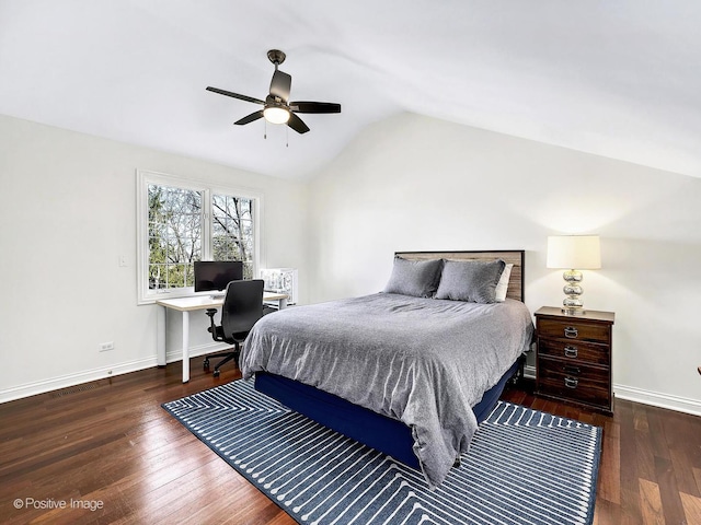 bedroom with baseboards, lofted ceiling, and hardwood / wood-style floors