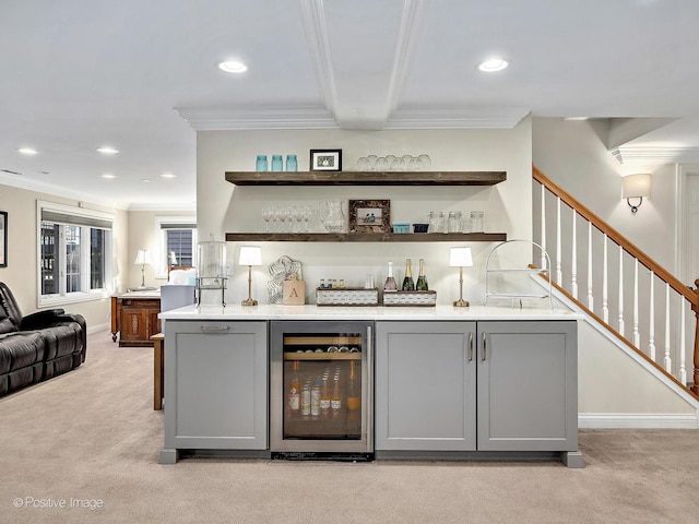 bar featuring crown molding, a dry bar, beverage cooler, and light carpet