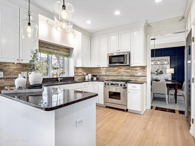 kitchen featuring white cabinetry, stainless steel appliances, and a sink