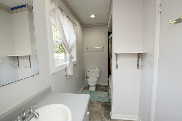 bathroom with recessed lighting, toilet, shower / bath combo, vanity, and baseboards