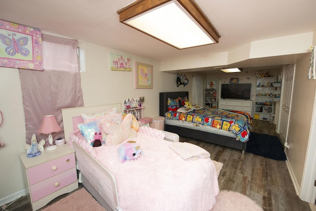 bedroom with wood finished floors and baseboards