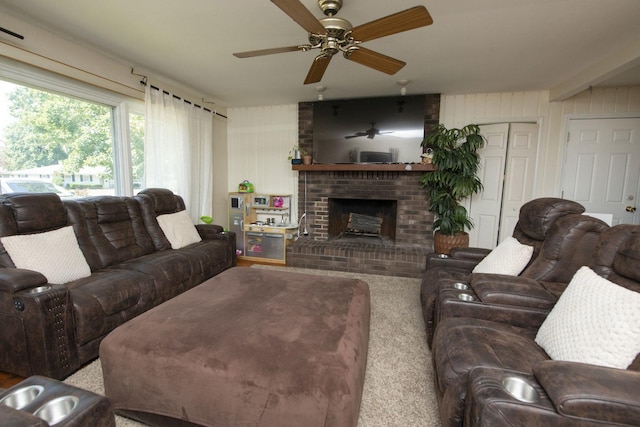 living area with a fireplace and a ceiling fan