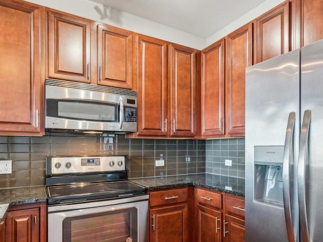 kitchen with stainless steel appliances, dark stone countertops, backsplash, and brown cabinets