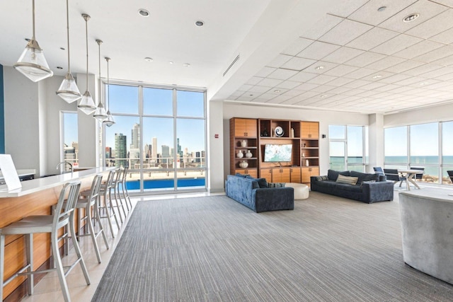 living area featuring carpet floors, recessed lighting, and floor to ceiling windows