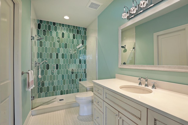 bathroom with visible vents, toilet, a shower stall, tile patterned flooring, and vanity