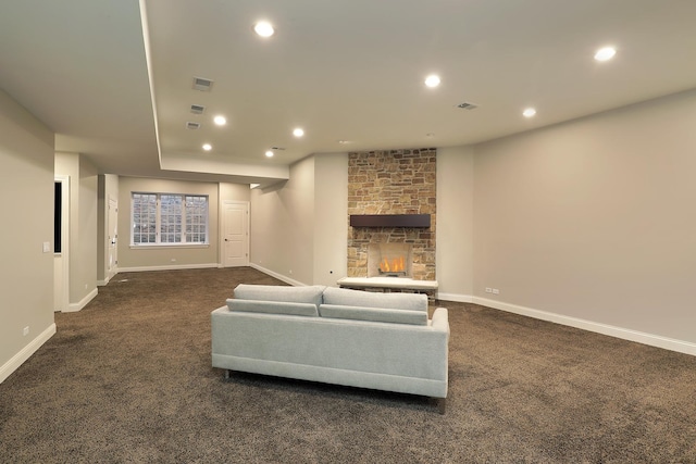 living room with carpet flooring, recessed lighting, a stone fireplace, and baseboards