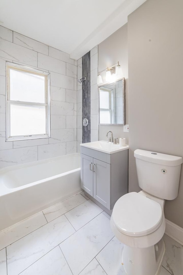 bathroom with toilet, marble finish floor, plenty of natural light, and shower / washtub combination