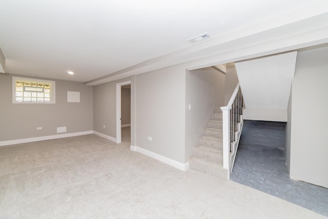 basement featuring visible vents, baseboards, and stairs