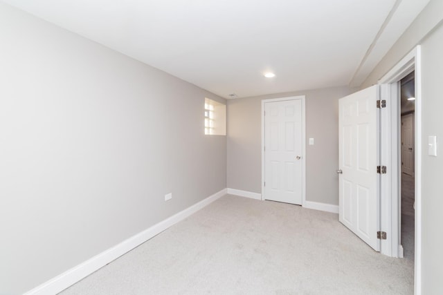 unfurnished bedroom with light carpet and baseboards