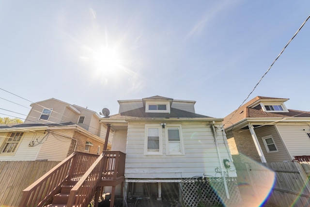 rear view of property with fence