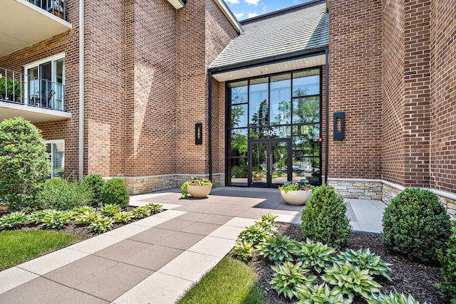 property entrance with french doors and brick siding