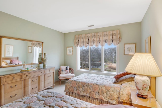 bedroom with visible vents and carpet flooring