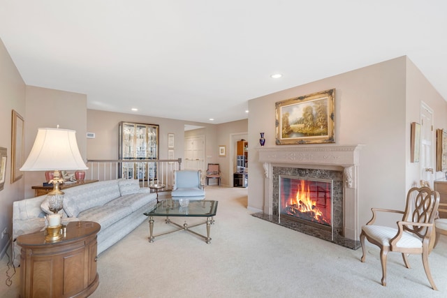 living room with carpet floors, recessed lighting, and a premium fireplace