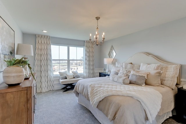 carpeted bedroom with a notable chandelier