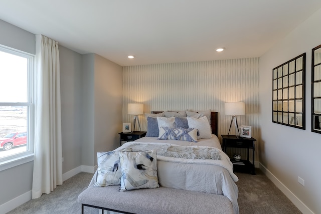 bedroom featuring carpet flooring, multiple windows, and baseboards