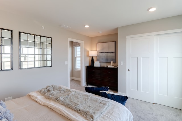 bedroom with recessed lighting, visible vents, baseboards, a closet, and carpet