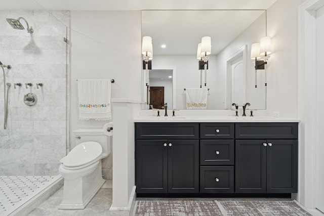 full bathroom with a sink, tiled shower, and toilet