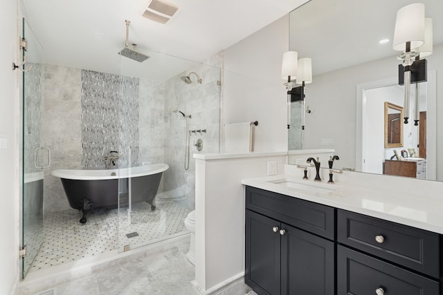 bathroom with visible vents, toilet, a stall shower, a soaking tub, and vanity