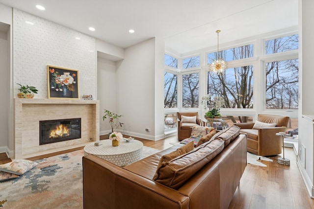 living room with a premium fireplace, plenty of natural light, and wood finished floors