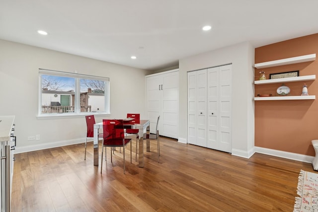 dining room featuring recessed lighting, baseboards, and wood finished floors