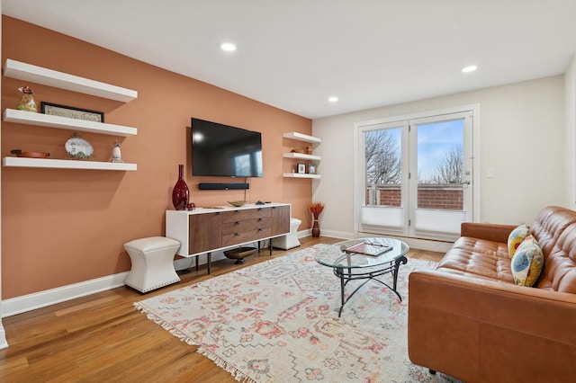 living area with recessed lighting, baseboards, and wood finished floors