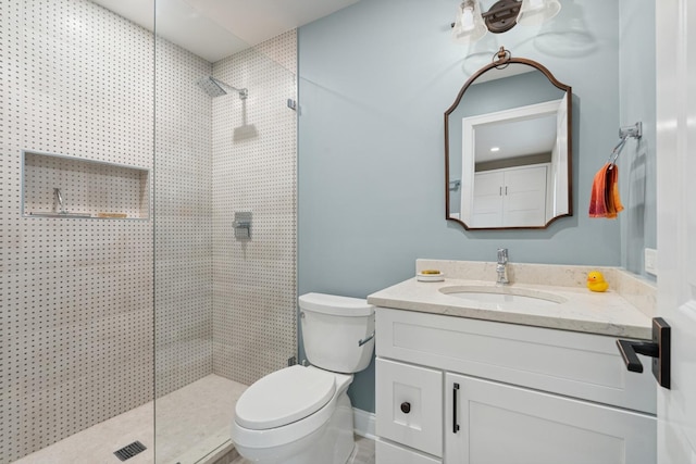 full bath featuring toilet, vanity, and a walk in shower