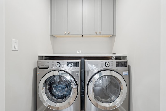 laundry room featuring cabinet space and separate washer and dryer