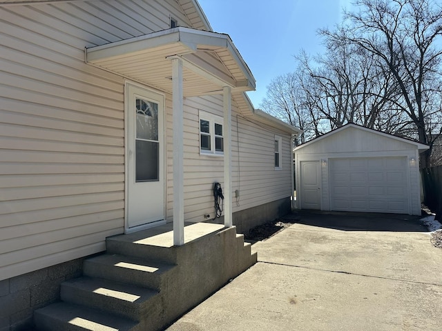 view of side of home with an outbuilding, driveway, and a garage