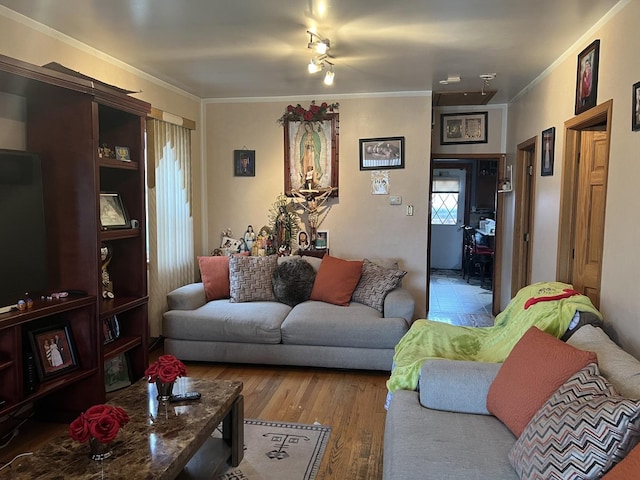 living room with ornamental molding and wood finished floors