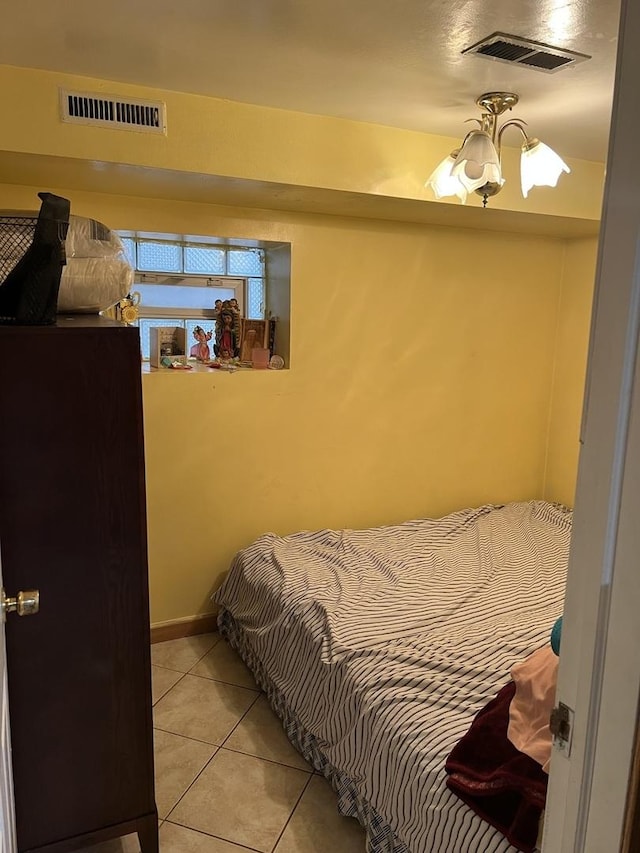 bedroom with light tile patterned floors, baseboards, and visible vents