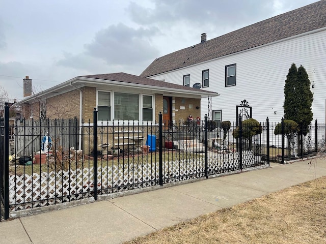 view of front of home featuring brick siding and fence