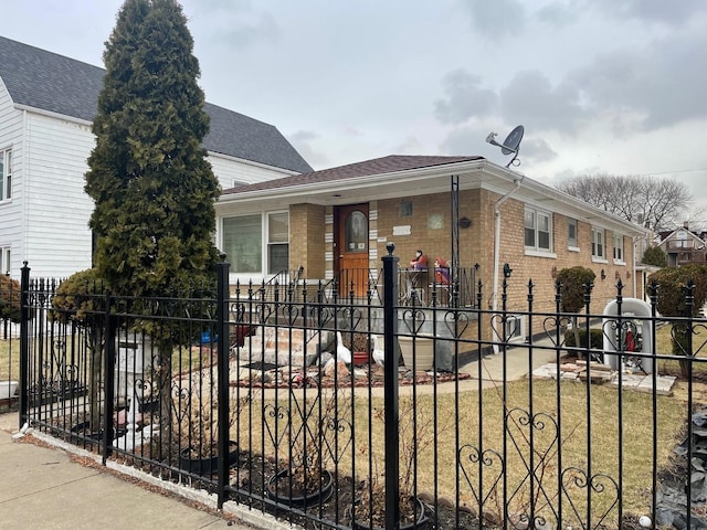 view of front of property with a fenced front yard, a shingled roof, and brick siding