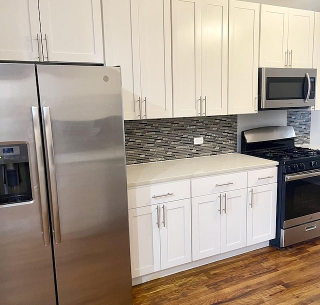 kitchen featuring appliances with stainless steel finishes, white cabinets, and light countertops