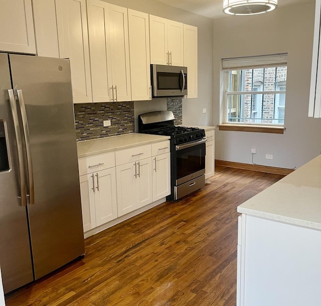 kitchen featuring stainless steel appliances, white cabinets, light countertops, tasteful backsplash, and dark wood finished floors