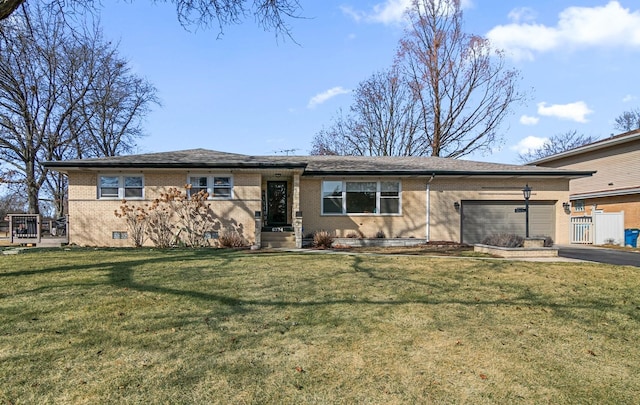 view of front of property with a garage, a front lawn, driveway, crawl space, and brick siding